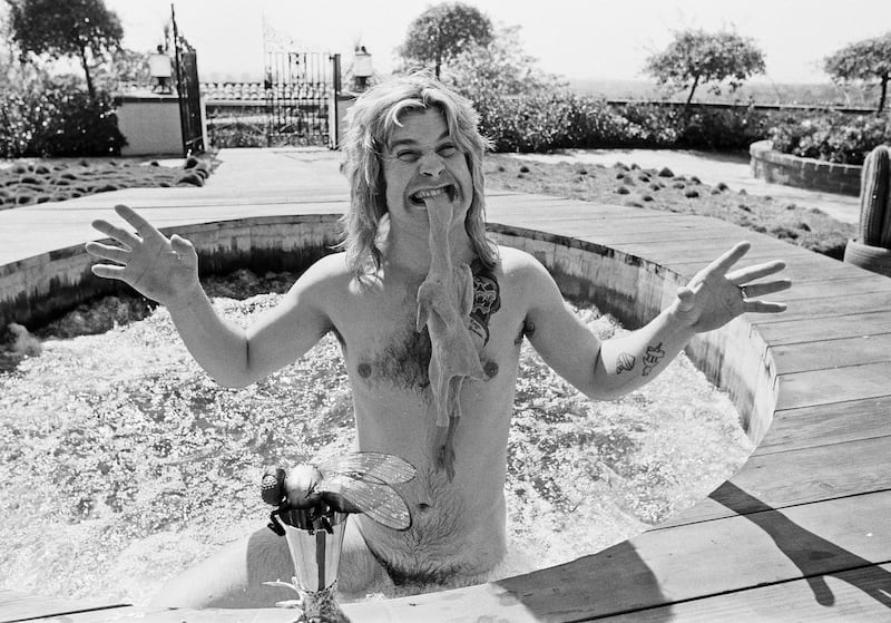 Ozzy Osbourne, former lead singer of Black Sabbath, in his hot tub at his luxury home in Goldwater Canyon, Beverly Hills, California biting the head of a rubber chicken on April 28, 1982.