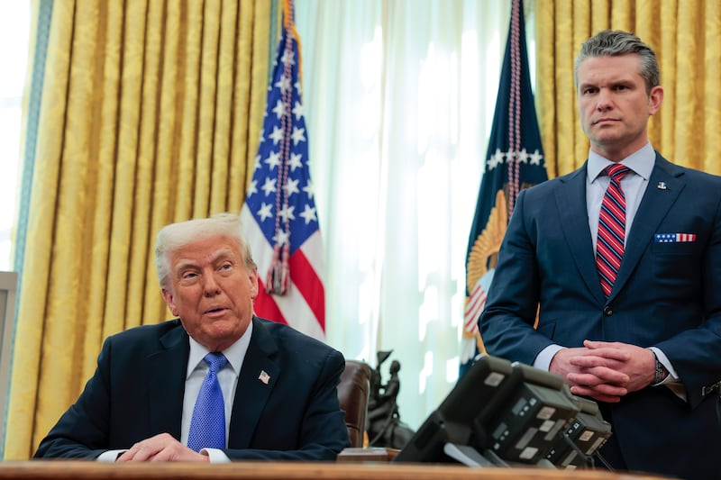 Trump and Hegseth in the Oval Office on March 21—the president has so far publicly supporting his embattled defense secretary