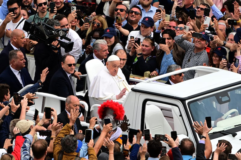 Pope Francis waves to the crowd from the popemobile after the Easter mass, at St Peter's square in the Vatican on April 20, 2025.