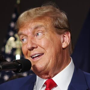 Donald Trump with a sign saying "Stop Biden's Border Bloodbath"