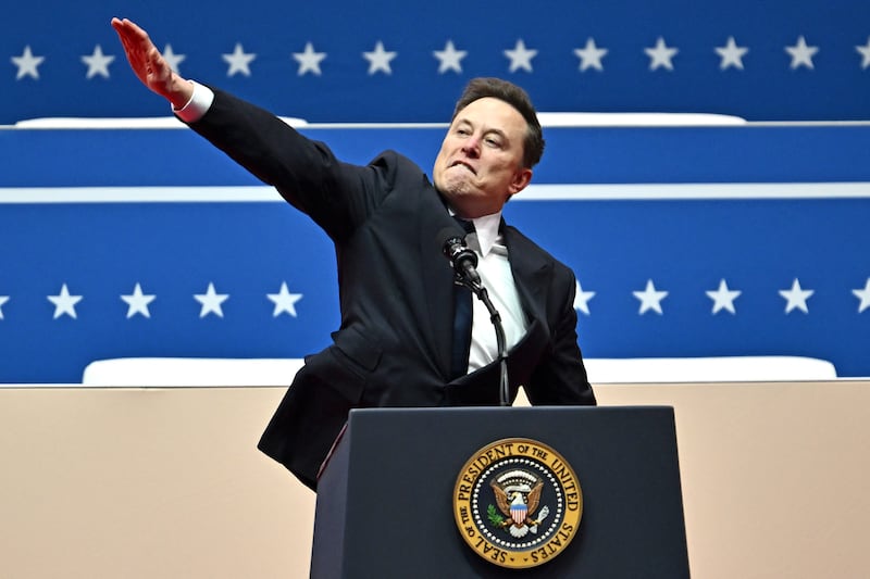 Elon Musk gestures in a move that looks like a Nazi salute as he speaks during the inaugural parade inside Capitol One Arena, in Washington, DC.