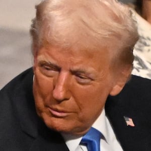 Donald Trump speaks with former President Barack Obama as they attend the State Funeral Service for former US President Jimmy Carter at the Washington National Cathedral in Washington, DC,