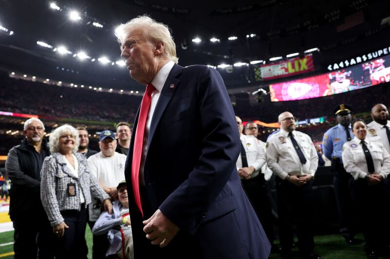 U.S. President Donald Trump reacts after posing with family members of victims in the January 1 attack on Bourbon Street and emergency responders prior to Super Bowl LIX between the Kansas City Chiefs and the Philadelphia Eagles at Caesars Superdome on February 09, 2025 in New Orleans, Louisiana.