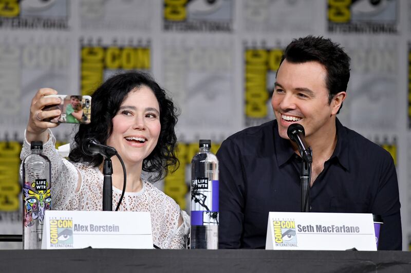 SAN DIEGO, CA - JULY 21:  Alex Borstein (L) and Seth MacFarlane take a selfie onstage at the "American Dad" and "Family Guy"  Panel during Comic-Con International 2018 at San Diego Convention Center on July 21, 2018 in San Diego, California.  (Photo by Mike Coppola/Getty Images)
