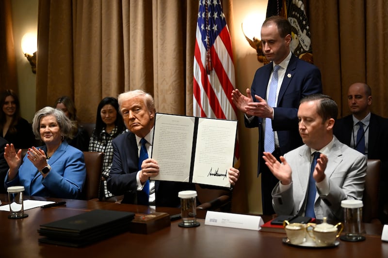 Sergio Gor sits to the left of President Donald Trump