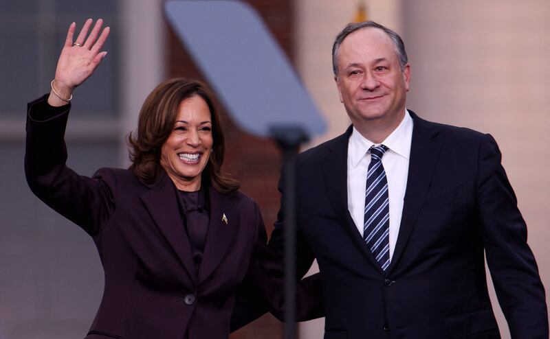 Democratic presidential nominee U.S. Vice President Kamala Harris waves next to her husband Doug Emhoff after she delivered remarks, conceding the 2024 U.S. presidential election to President-elect Donald Trump, at Howard University in Washington, U.S., November 6, 2024. REUTERS/Hannah McKay