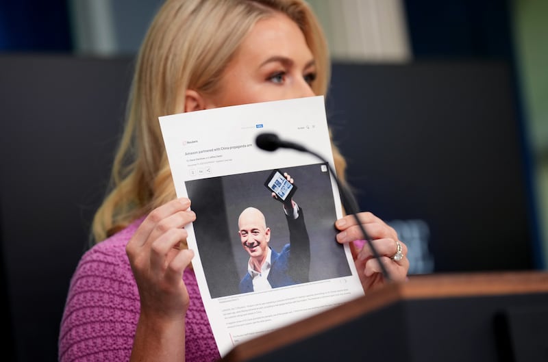 Karoline Leavitt holds up a printed article about Amazon founder Jeff Bezos. She slammed the billionaire over a report Amazon will soon display how much President Donald Trump’s tariffs have spiked prices on products.