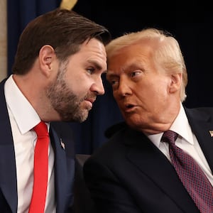 Donald Trump whispers to J.D. Vance as they arrive to Trump's inauguration ceremony at the U.S. Capitol on January 20, 2025.