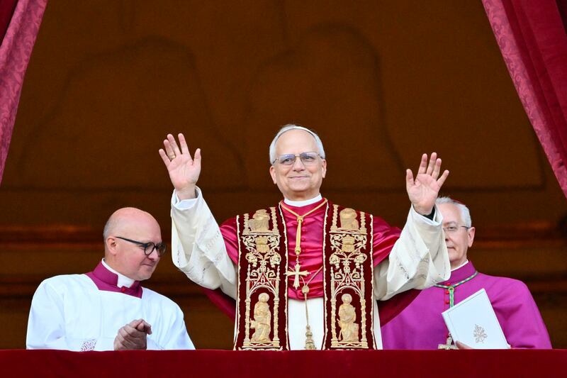 Newly elected Pope Robert Francis Prevost arrives on the main central loggia balcony of the St Peter's Basilica for the first time, after the cardinals ended the conclave, in The Vatican, on May 8, 2025. Robert Francis Prevost was on Thursday elected the first pope from the United States, the Vatican announced. A moderate who was close to Pope Francis and spent years as a missionary in Peru, he becomes the Catholic Church's 267th pontiff, taking the papal name Leo XIV.