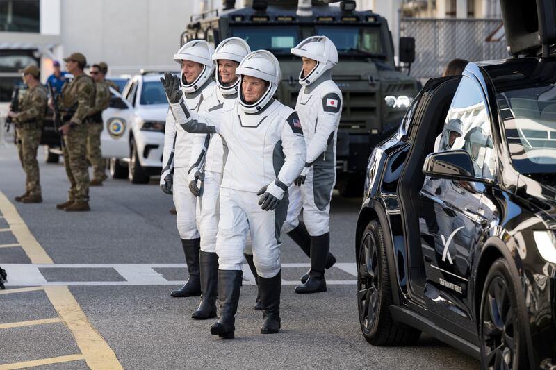 In this NASA handout, NASA astronauts Anne McClain and Nichole Ayers, JAXA (Japan Aerospace Exploration Agency) astronaut Takuya Onishi, and Roscosmos cosmonaut Kirill Peskov, wearing SpaceX spacesuits, are seen as they prepare to depart the Neil A. Armstrong Operations and Checkout Building for Launch Complex 39A on NASA's Kennedy Space Center to board the SpaceX Dragon spacecraft for the Crew-10 mission launch, Wednesday, March 12, 2025, at NASA's Kennedy Space Center in Florida.
