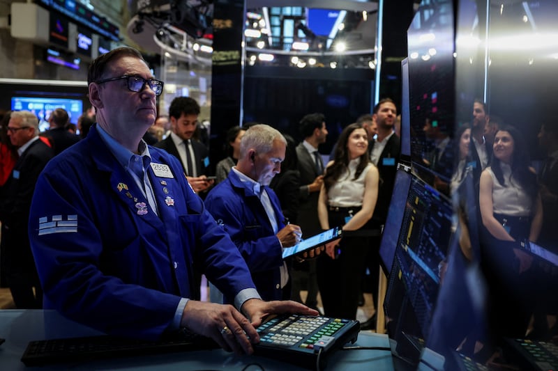Traders work on the floor at the New York Stock Exchange (NYSE) in New York City, U.S., May 19, 2025. REUTERS/Jeenah Moon