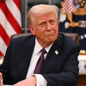 US President Donald Trump signs executive orders in the Oval Office of the White House in Washington, DC, on January 20, 2025.