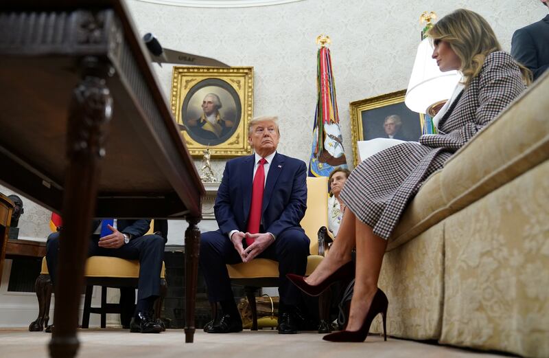 U.S. President Donald Trump looks over at first lady Melania Trump as he meets with Guatemala's President Jimmy Morales in the Oval Office at the White House in Washington, U.S., December 17, 2019. REUTERS/Kevin Lamarque