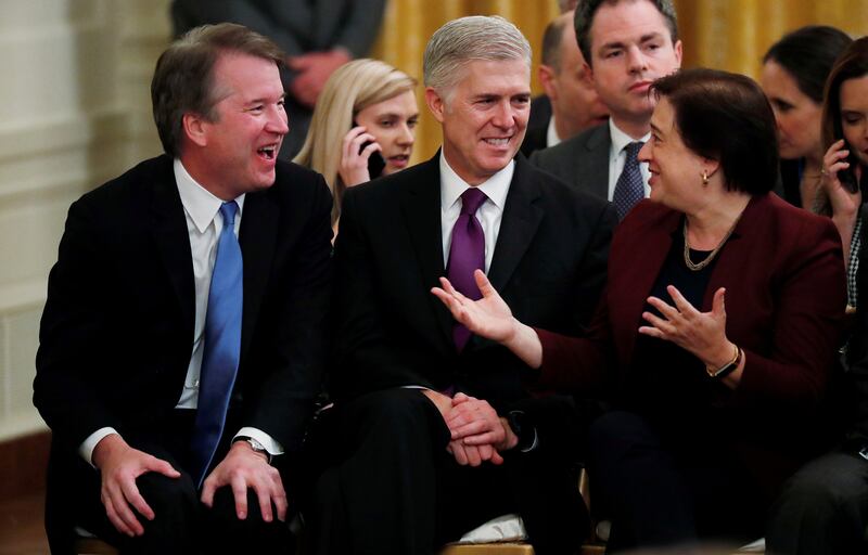 Supreme Court Associate Justices Brett Kavanaugh, Neil Gorsuch and Elena Kagan talk during a ceremony at the White House