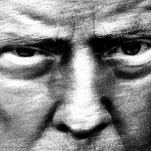Black and white close up photograph of Donald Trump with an intense stare