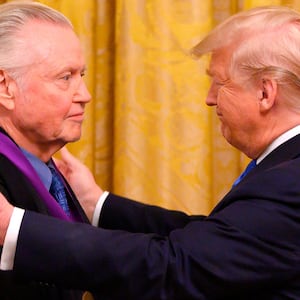 US President Donald Trump awards the National Medal of Arts to actor Jon Voight (L) in 2019.