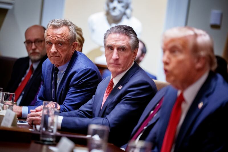 (L-R) Office of Management and Budget Director Russell Vought, U.S. Health and Human Services Secretary Robert F. Kennedy Jr., and Interior Secretary Doug Burgum, listen as U.S. President Donald Trump speaks during a Cabinet meeting at the White House on February 26, 2025 in Washington, DC.