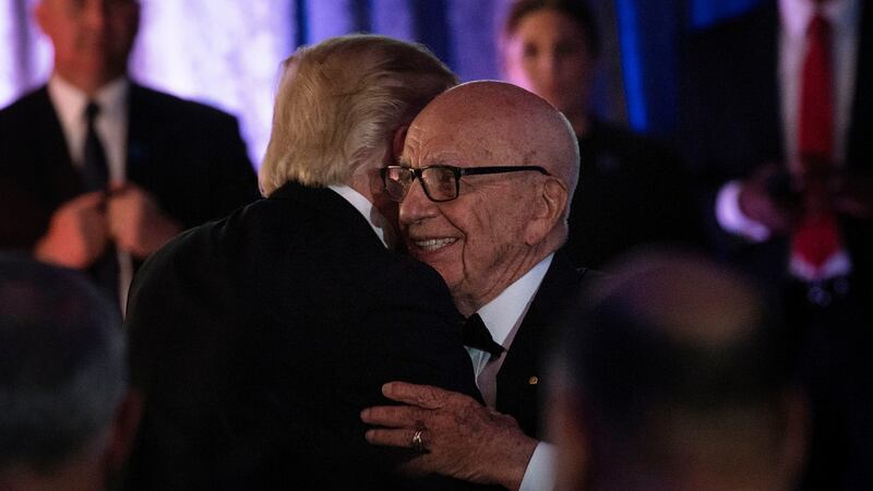 Trump and Murdoch embrace at a 2017 dinner commemorating the 75th anniversary of the Battle of the Coral Sea during WWII.