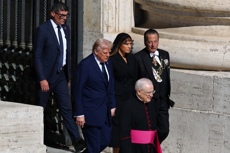 U.S President Donald Trump and first lady Melania Trump walk to attend  the funeral Mass of Pope Francis, at the Vatican, April 26, 2025.