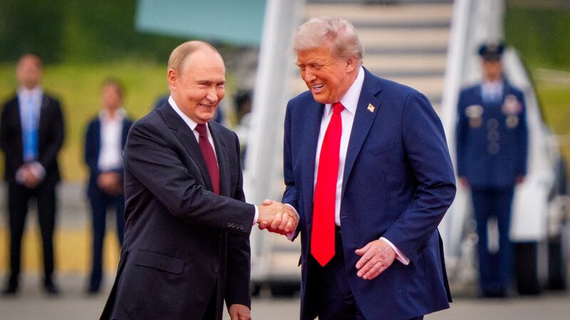 ANCHORAGE, ALASKA - AUGUST 15: (EDITOR'S NOTE: Alternate Crop) U.S. President Donald Trump (R) greets Russian President Vladimir Putin as he arrives at Joint Base Elmendorf-Richardson on August 15, 2025 in Anchorage, Alaska. The two leaders are meeting for peace talks aimed at ending the war in Ukraine. (Photo by Andrew Harnik/Getty Images)