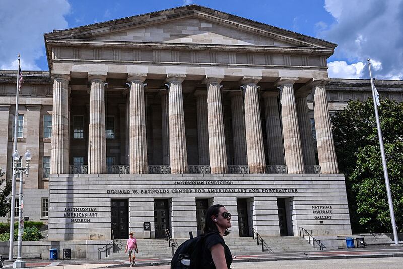 Visitors walk outside the Smithsonian American Art Museum and the National Portrait Gallery is seen in Washington, DC on August 14, 2025. US President Donald Trump on Tuesday criticized top museums for their "woke" focus on subjects including "how bad Slavery was," his latest attack on the cultural institutions in a country that fought a civil war over the issue. (Photo by Alex WROBLEWSKI / AFP) (Photo by ALEX WROBLEWSKI/AFP via Getty Images)