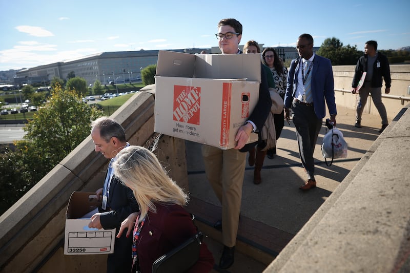 ARLINGTON, VIRGINIA - OCTOBER 15: Pentagon reporters walk out of the building carrying their belongings after turning in their press badges October 15, 2025 in Arlington, Virginia. Reporters from nearly every major news organization opted to turn in their press passes rather than sign new rules viewed as an infringement on First Amendment rights that also could have limited their ability to report independently on the U.S military. (Photo by Win McNamee/Getty Images)