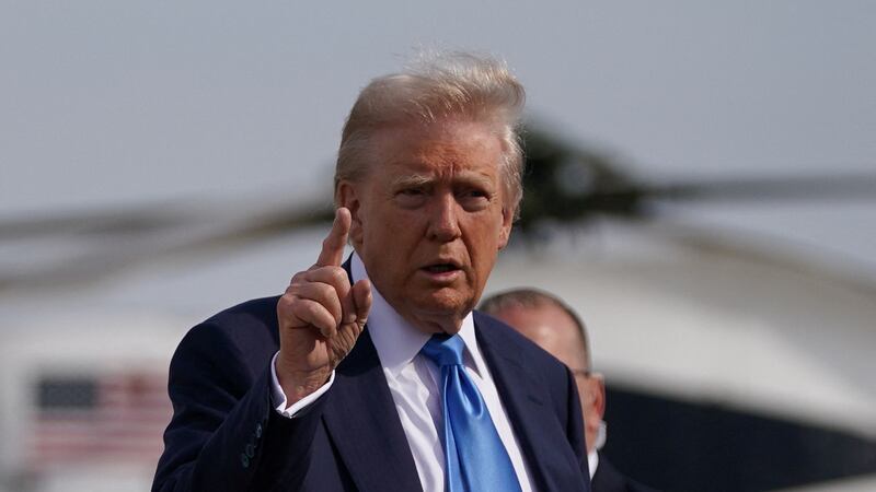 U.S. President Donald Trump gestures as he walks to board Air Force One as he departs for Rome, Italy, to attend Pope Francis' funeral.