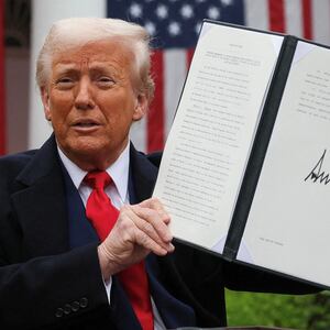 U.S. President Donald Trump holds a signed executive order on tariffs, in the Rose Garden at the White House in Washington, D.C., U.S., April 2, 2025. REUTERS/Leah Millis/File Photo