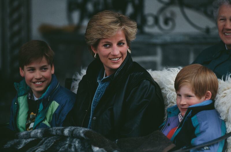 Diana, Princess of Wales riding in a traditional sleigh with Prince William and Prince Harry during a skiing holiday in Lech, Austria