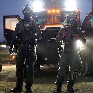 Federal agents block people protesting an ICE immigration in California.