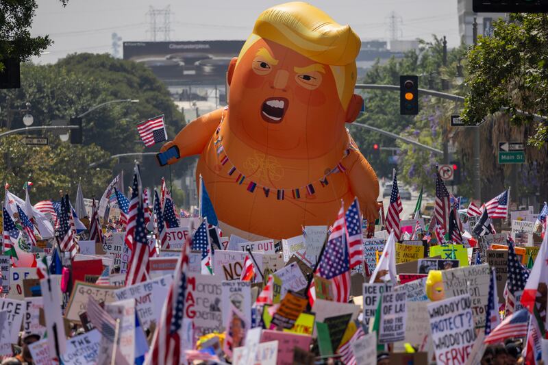 LOS ANGELES, CALIFORNIA - JUNE 14: People march during a "No Kings" movement protest in the one-square mile area where daily protests have been occurring in response to a series of federal immigration raids on June 14, 2025 in Los Angeles, California. Hundreds of marches and protests against the Trump administration are happening across the United States in opposition to Trump policies on the same day as President Trump's 79th birthday and a military parade on the 250th anniversary of the U.S. Army in Washington, DC. (Photo by David McNew/Getty Images)