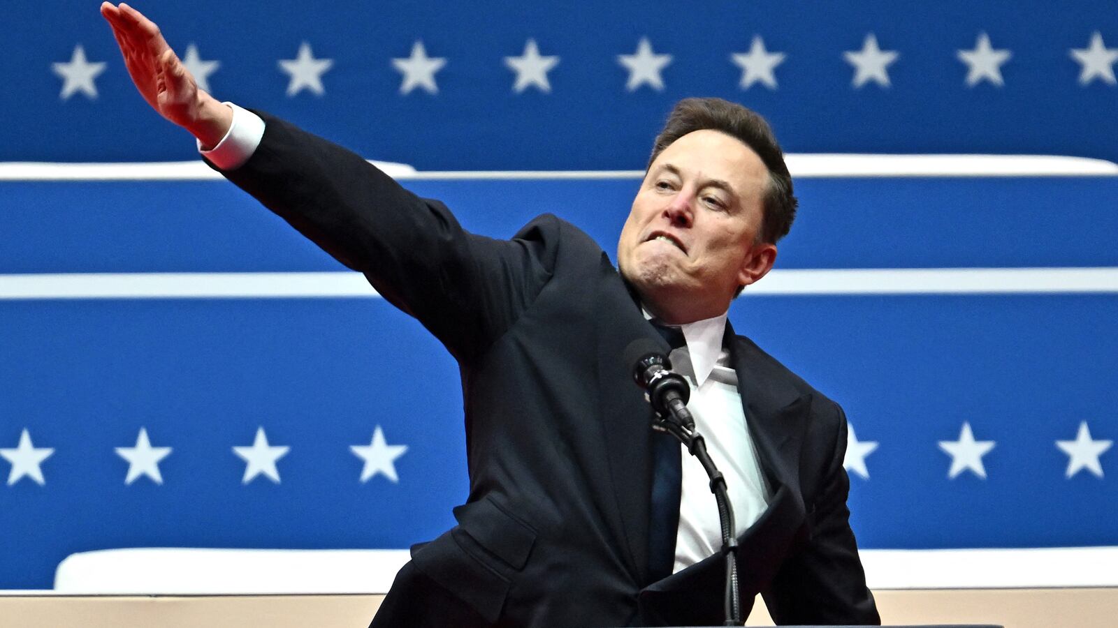 TOPSHOT - Tesla and SpaceX CEO Elon Musk gestures as he speaks during the inaugural parade inside Capitol One Arena, in Washington, DC, on January 20, 2025. (Photo by ANGELA WEISS / AFP) (Photo by ANGELA WEISS/AFP via Getty Images)