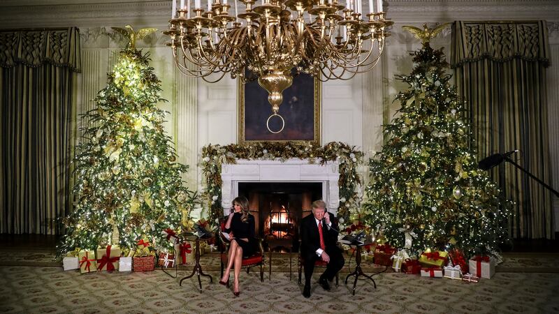 President Donald Trump and first lady Melania Trump speak on the phone with children as they track Santa Claus with the North American Aerospace Defense Command, NORAD.