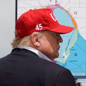 Donald Trump talks with Florida Governor Ron DeSantis during a visit to Lake Okechobee and the Herbert Hoover Dike in Canal Point, Florida.