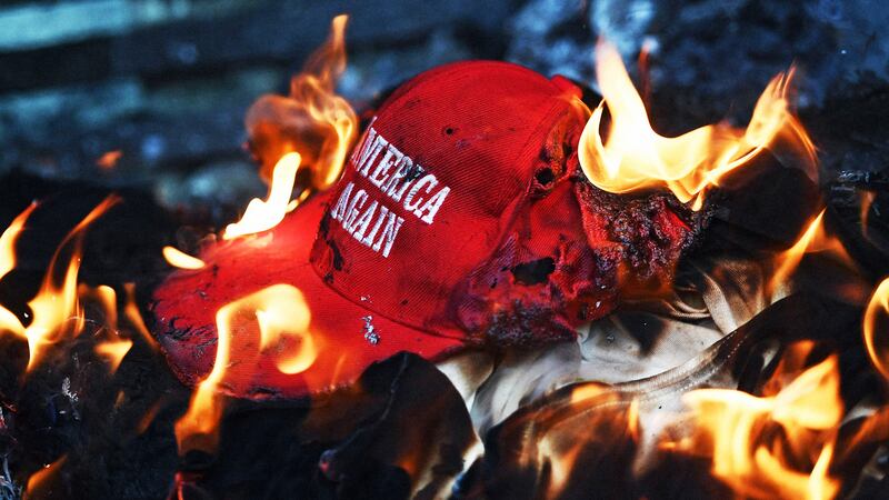 A "Make America Great Again" hat on fire.