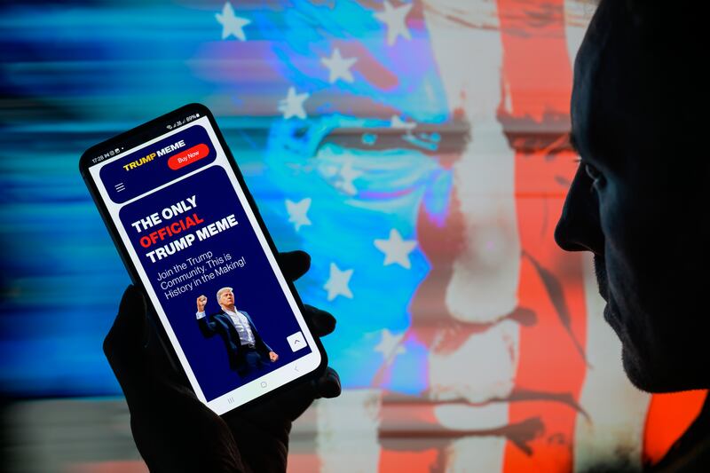 The $TRUMP meme crypto coin web page is displayed on a mobile screen in this photo illustration in Brussels, Belgium, on January 19, 2025. (Photo by Jonathan Raa/NurPhoto via Getty Images)