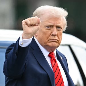 US President Donald Trump gestures as he exits his motorcade to walk to Marine One upon departure from Walter Reed National Military Medical Center after a medical checkup in Bethesda, Maryland, on October 10, 2025. (Photo by ANDREW CABALLERO-REYNOLDS / AFP)