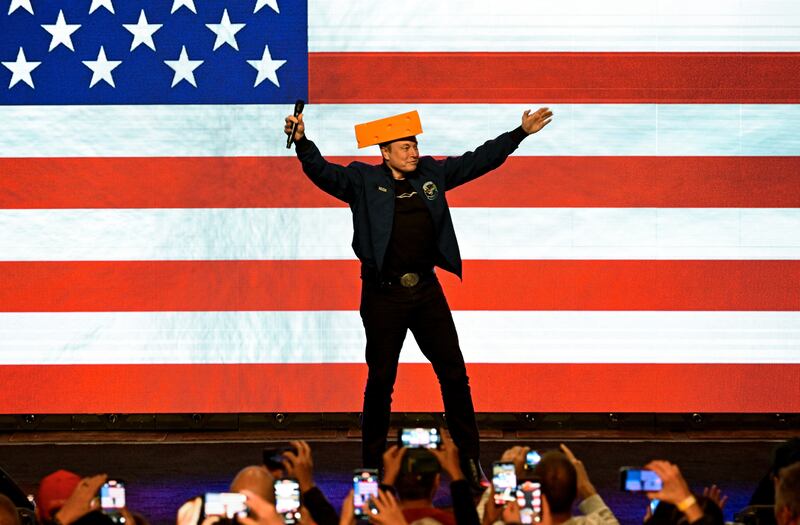 U.S. President Donald Trump's adviser Elon Musk wears a cheese hat as he holds a rally in support of a conservative state Supreme Court candidate of an April 1 election in Green Bay, Wisconsin, U.S. March 30, 2025.  REUTERS/Vincent Alban