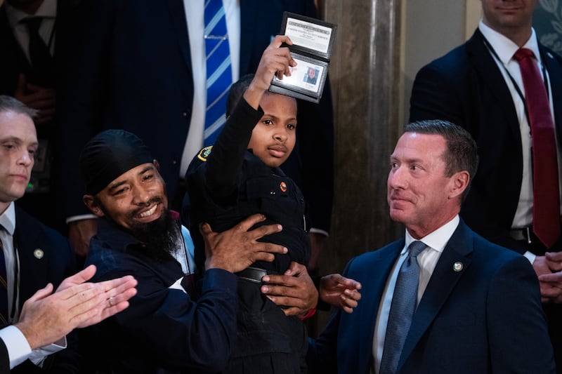 D.J. Daniel, a 13-year-old cancer survivor, receives an honorary special agent certificate from Secret Service Director Sean Curran, right, during President Donald Trump's address to a joint session of Congress