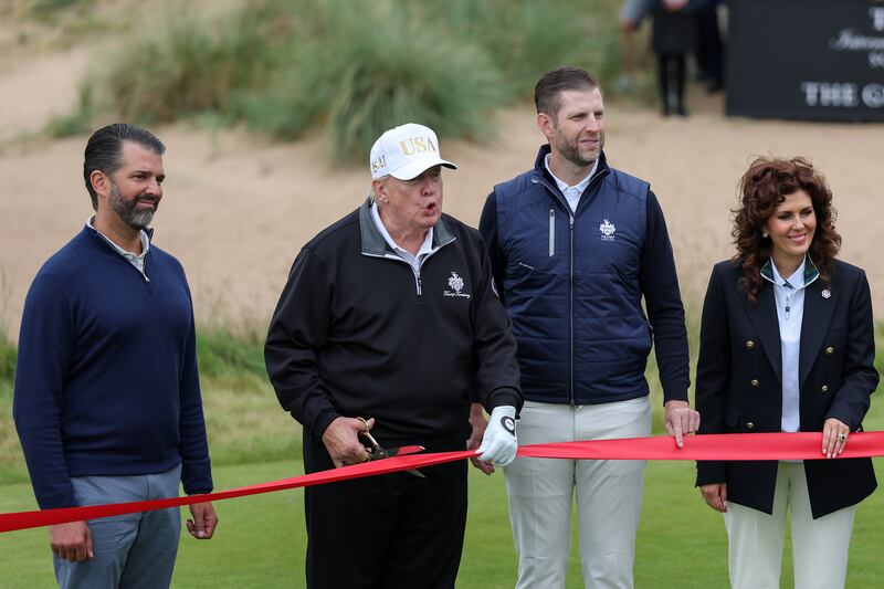 BALMEDIE, SCOTLAND - JULY 29: U.S. President Donald Trump cuts the ribbon next to Donald Trump Jr. (L) Eric Trump (2nd R) and Sarah Malone, Executive Vice President and general manager of Trump international Golf Links Scotland (R) at the ribbon-cutting ceremony at a new 18-hole course at Trump International Golf Links on July 29, 2025 in Balmedie, near Aberdeen, Scotland.