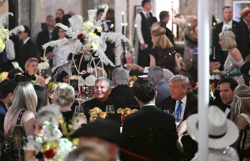 PALM BEACH, FLORIDA - OCTOBER 31: US President Donald Trump talks with guests during a Halloween party at his Mar-a-Lago estate on October 31, 2025 at Palm Beach, Florida. Trump is spending the weekend at his Mar-A-Lago estate in Palm Beach, Florida. (Photo by Samuel Corum/Getty Images)