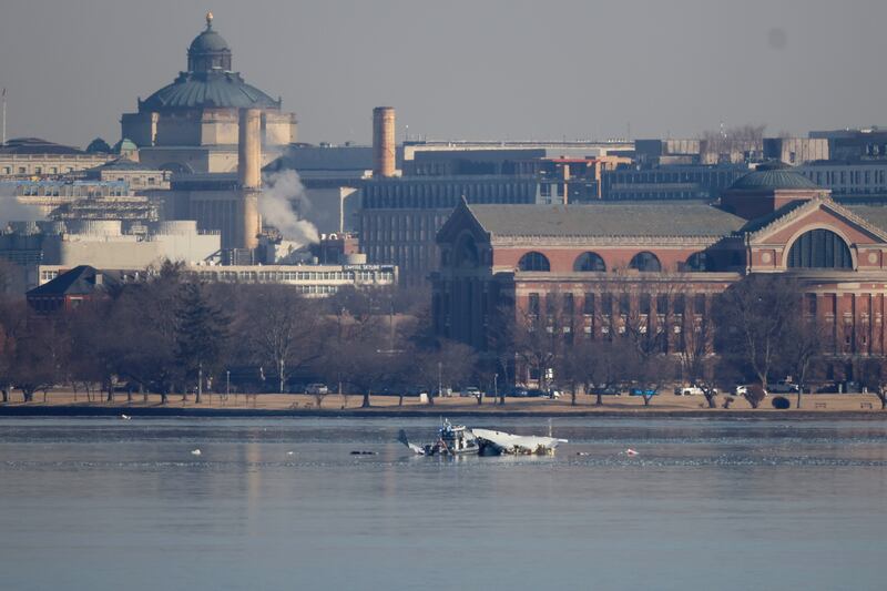 Emergency response units search the crash site of the American Airlines plane on the Potomac River.