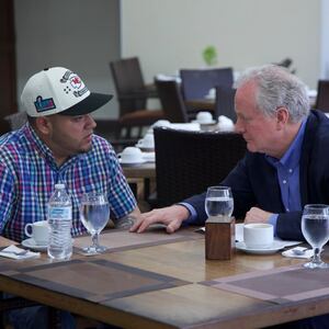 Kilmar Abrego Garcia and Senator Chris Van Hollen sit at a table in a restaurant.