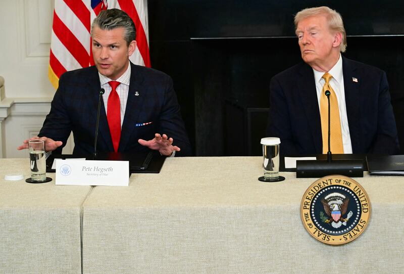 US President Donald Trump listens to Defense Secretary Pete Hegseth during a law enforcement roundtable in the State Dining Room