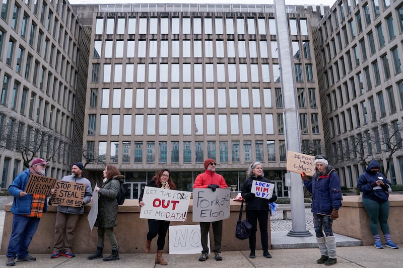 People gather to protest outside the Office of Personnel Management (OPM) headquarters after the Elon Musk-led Department of Government Efficiency (DOGE) was charged with oversight of OPM, in Washington, U.S. February 2, 2025.