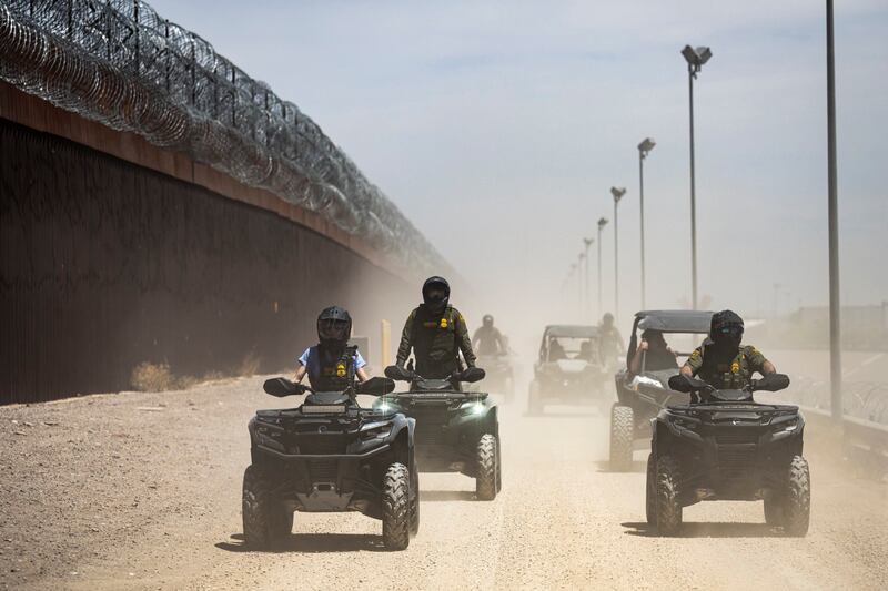 Homeland Security Secretary Kristi Noem rides an ATV along the U.S.-Mexico border.