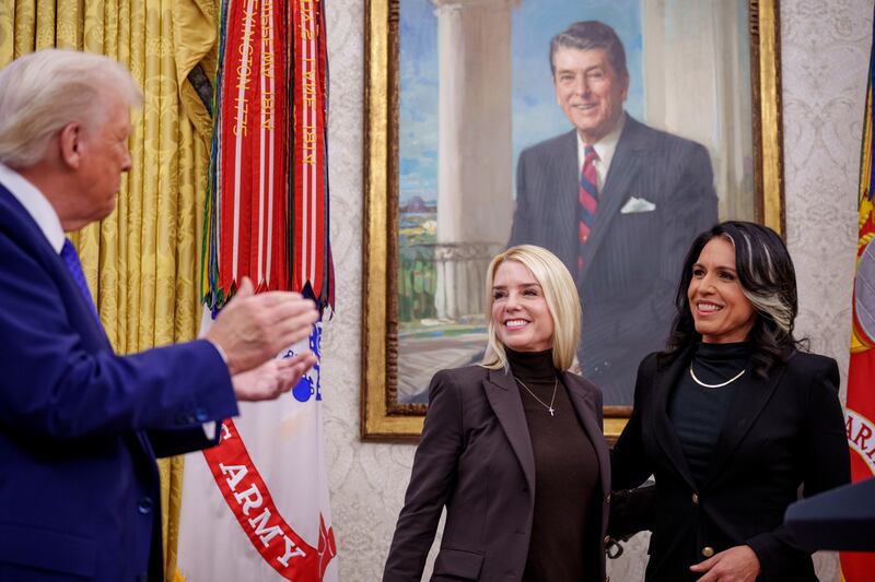 President Donald Trump claps after Tulsi Gabbard is sworn in as Director of National Intelligence by Attorney General Pam Bondi in the Oval Office at the White House on February 12, 2025 in Washington, D.C.