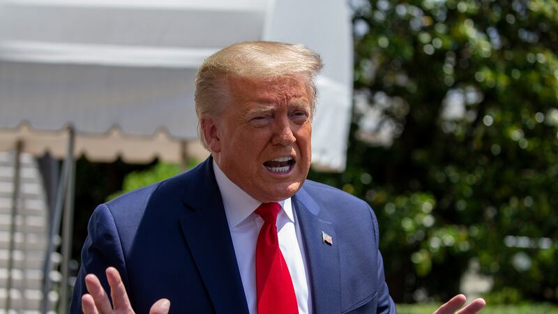 WASHINGTON, DC - MAY 30: U.S. President Donald Trump talks to the media outside the White House as he heads to the SpaceX launch in Florida on May 30, 2020 in Washington, DC. President Donald Trump warned that protesters outside the White House Friday night could have been "greeted" with "vicious dogs" and "ominous weapons" if they had breached the fence, and praised the Secret Service for their response to the demonstrations. (Photo by Tasos Katopodis/Getty Images)