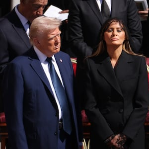 President Donald Trump and US First Lady Melania Trump standing before Pope Francis' funeral.