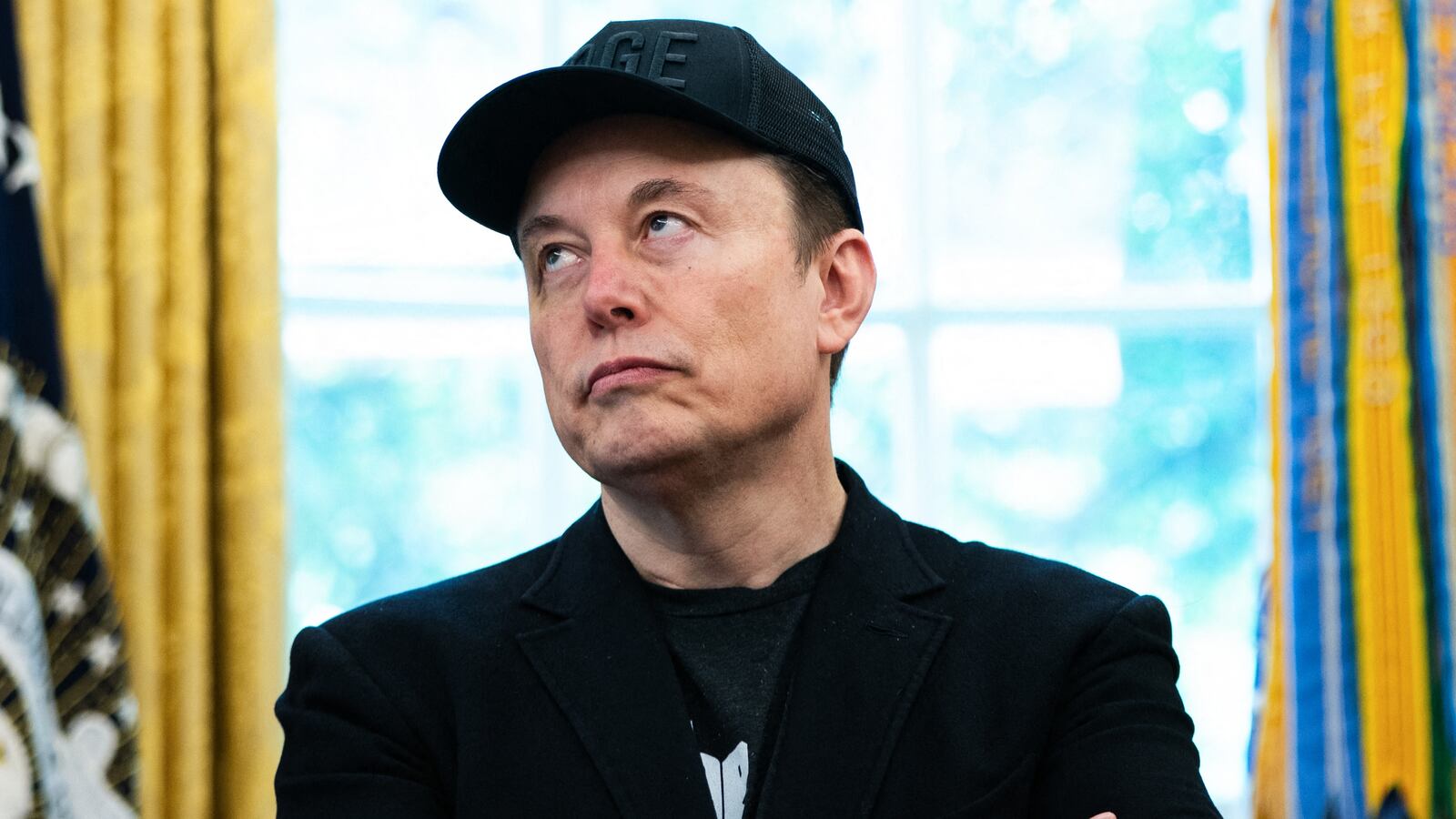 Elon Musk looks on during a news conference with US President Donald Trump in the Oval Office of the White House in Washington, DC, on May 30, 2025. Musk, who stormed into US politics as President Trump's chainsaw-brandishing sidekick, announced on May 28 that he is leaving his role in US government, intended to reduce federal spending, shortly after his first major break with the President over Trump's signature spending bill. (Photo by Allison ROBBERT / AFP) (Photo by ALLISON ROBBERT/AFP via Getty Images)